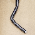 A vine robot bent with dynamically reconfigurable stiffness.